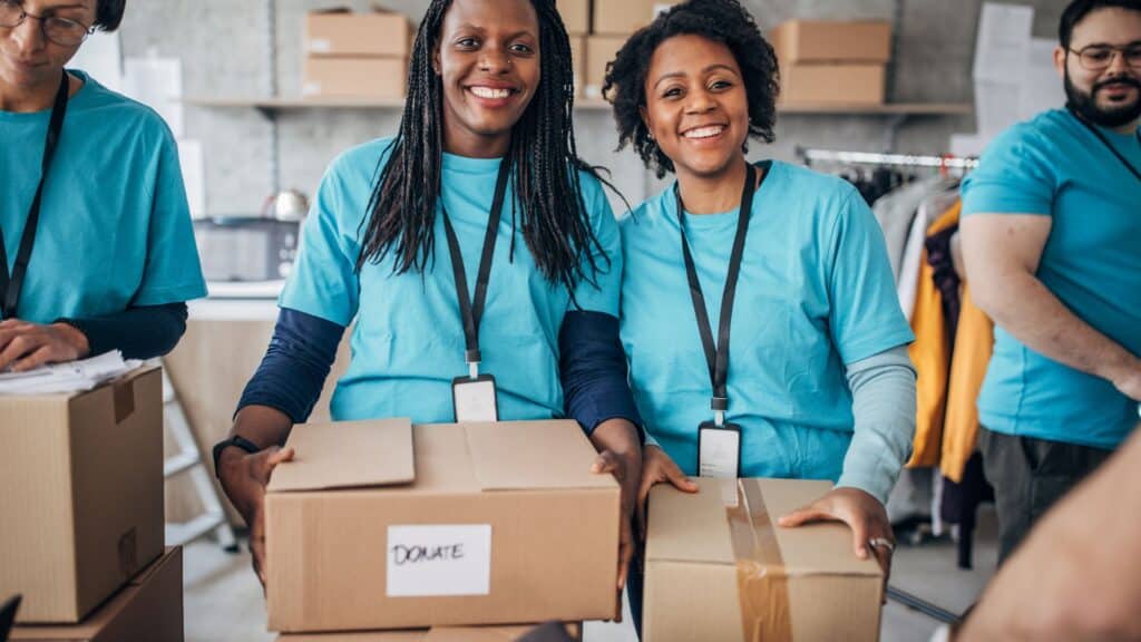 Black woman with volunteers friends in charity
